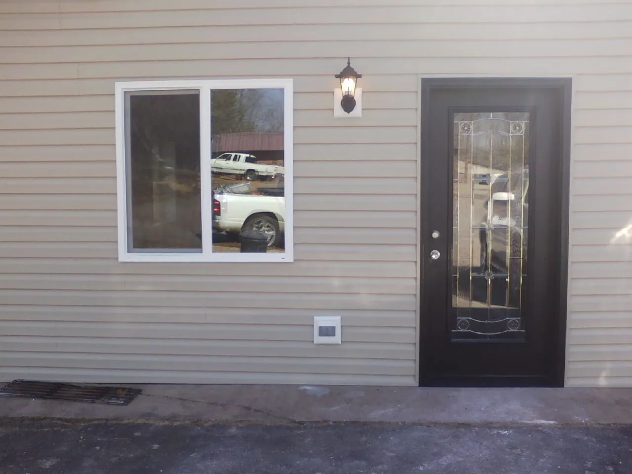 New siding, window and entry door on the side of an addition in Mill Creek